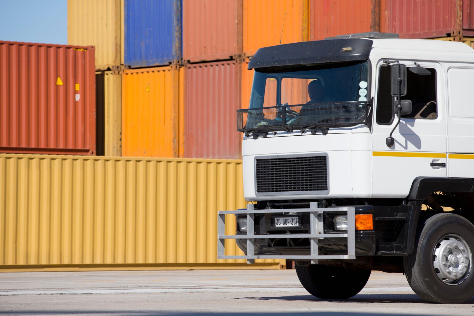 close-up-of-a-truck-at-a-dockyard-and-stacked-carg-2026-03-26-08-17-18-utc